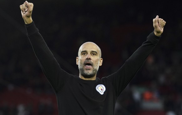 epa09504169 Manchester City manager Pep Guardiola celebrates after the English Premier League soccer match between Liverpool FC and Manchester City in Liverpool, Britain, 03 October 2021. EPA/Andrew Y ...