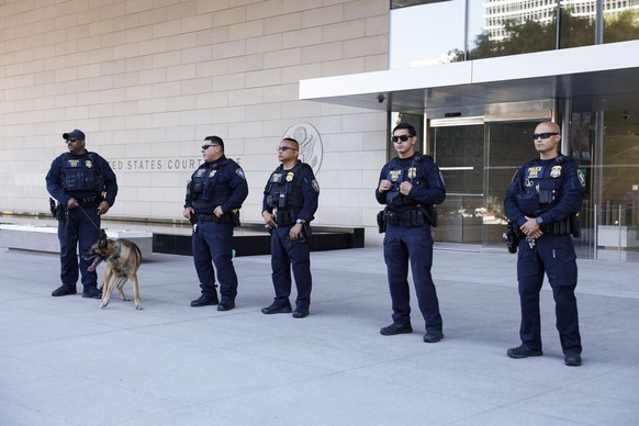 epa11588435 Department of Homeland Security officers stand outside the First Street US Courthouse shortly after Hunter Biden departed in Los Angeles, California, USA, 05 September 2024. Hunter Biden p ...