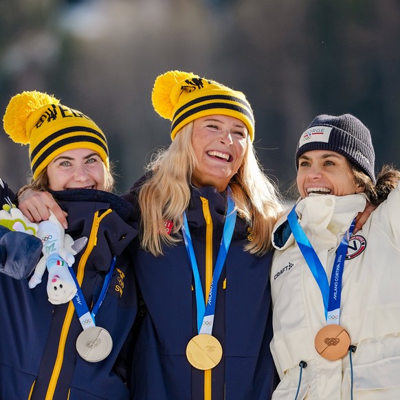 Silver medalist Ebba Andersson of Sweden, gold medalist Frida Karlsson of Sweden and bronze medalist Heidi Weng of Norway, from left, pose together after the cross country skiing women's 10km + 1 ...