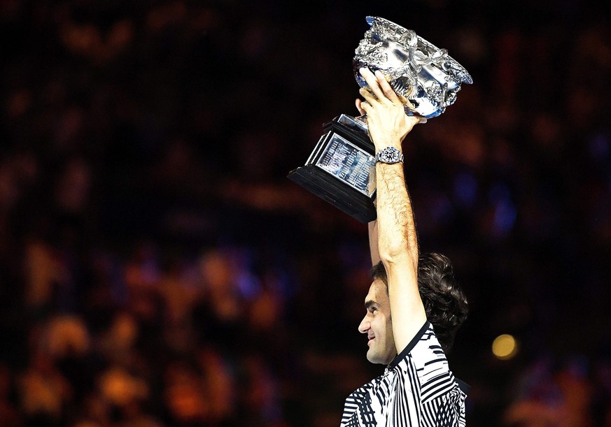 epa05759201 Roger Federer of Switzerland celebrates with the trophy after winning the Men&#039;s Singles final match against Rafael Nadal of Spain at the Australian Open Grand Slam tennis tournament i ...