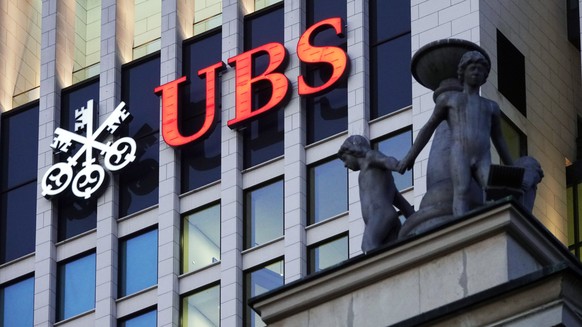 epa08963649 (FILE) - An image showing Swiss UBS bank signage behind the statues on the facade of Old Opera building in Frankfurt, Germany, 20 January 2020 (reissued 25 January 2021). UBS is to release ...