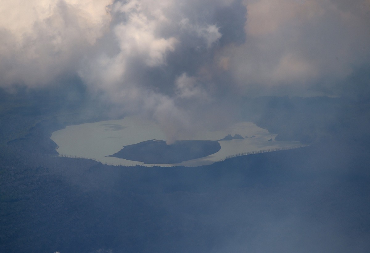 This Tuesday, Sept. 26, 2017 photo provided by the New Zealand Defense Force, shows huge columns of smoke, ash and volcanic rocks billowing from the crater of an erupting volcano on Vanuatu's Amb ...