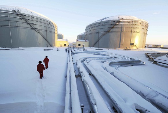 FILE - In this photo released by China&#039;s Xinhua News Agency, workers inspect the pipelines and oil storage tanks of a nearly 1, 000-kilometer (625-miles) -long China and Russia crude oil pipeline ...