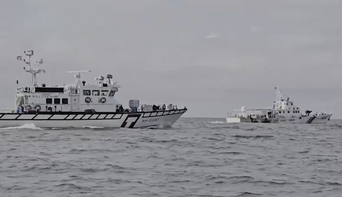 In this image from a video released by Taiwan Coast Guard Administration, a Taiwanese Coast Guard Administration ship, left, chases a Chinese Coast Guard ship near Kinmen County, Taiwan Thursday, July ...