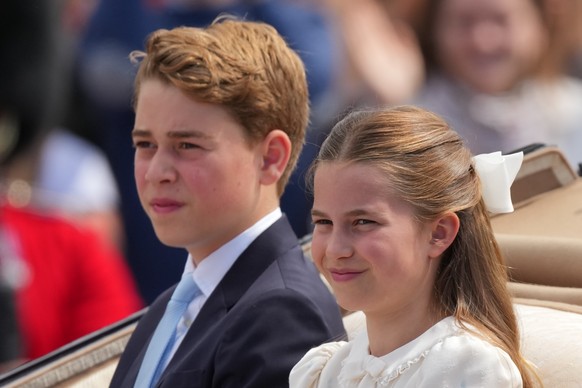 Britain's Prince George and Princess Charlotte ride on an open top carriage during Trooping The Colour, the King's annual birthday parade, in London, Saturday, June 13, 2026. (AP Photo/Kirst ...
