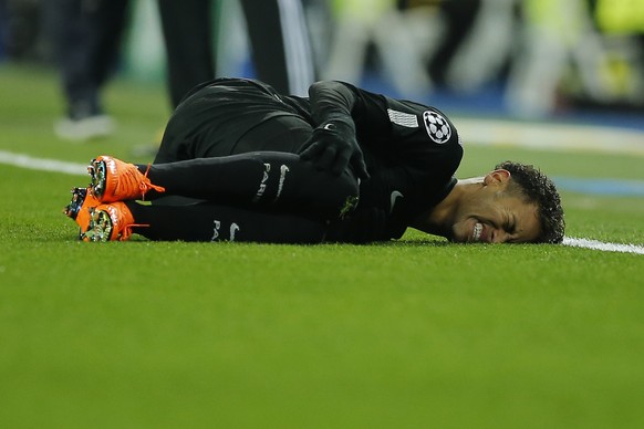 PSG&#039;s Neymar lies on the pitch after being fouled during the Champions League soccer match, round of 16, 1st leg between Real Madrid and Paris Saint Germain at the Santiago Bernabeu stadium in Ma ...