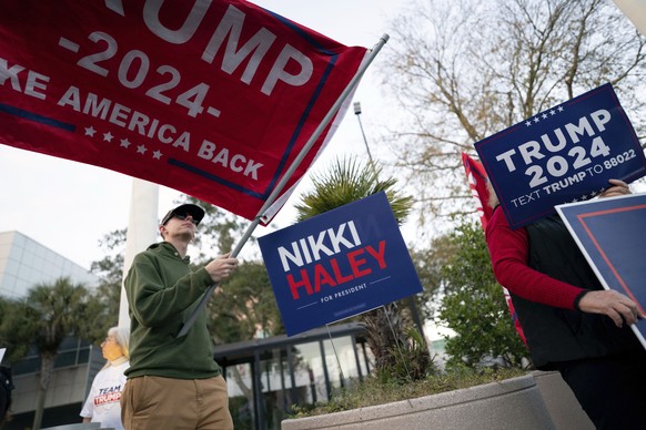 Supporters of Republican presidential candidate, former President Donald Trump, hold signs outside a campaign event for Republican presidential candidate, former U.N. Ambassador Nikki Haley, at The N...