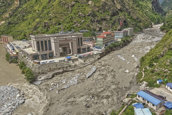 Chinese land on left, and Nepalese land on right are seen after Friendship bridge, a key bridge over the Bhotekoshi River connecting Nepal with China was swept away in monsoon rain at Rasuwagadi, 120  ...
