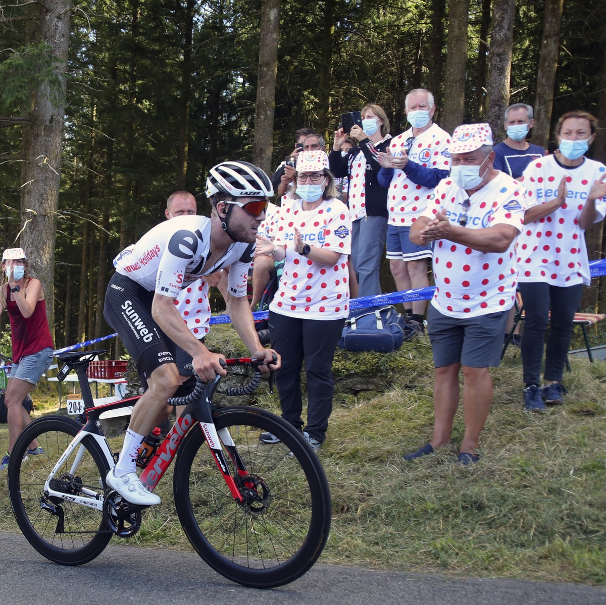 Spectators cheer Switzerland's Marc Hirschi as he climbs Suc au May pass during the stage 12 of the Tour de France cycling race over 218 kilometers from Chauvigny to Sarran, Thursday, Sept. 10, 2 ...