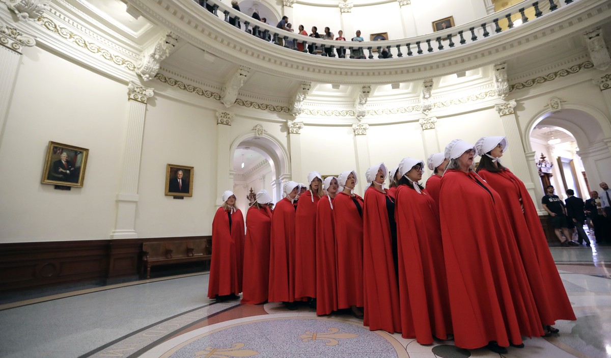 Activists dressed as characters from "The Handmaid's Tale" chant in the Texas Capitol Rotunda as they protest SB8, a bill that would require health care facilities, including hospitals  ...