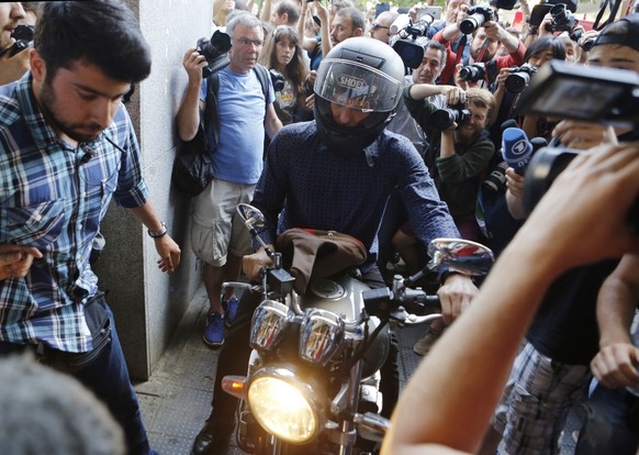 Outgoing Greek Finance Minister Yanis Varoufakis tries to leave on his motorcycle surrounded by media, after his resignation in Athens, Monday, July 6, 2015. Greece and its membership in Europe&#039;s ...