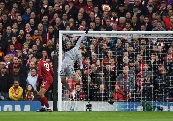 epa07554468 Liverpool goalkeeper Alisson Becker makes a save during the UEFA Champions League semi final second leg soccer match between Liverpool FC and FC Barcelona at Anfield, Liverpool, Britain, 0 ...
