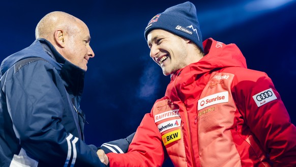 Fourth placed Marco Odermatt of Switzerland talks with Johan Eliasch, President of the International Ski Federation, FIS, during the medals ceremony of the men's super-g race at the 2023 FIS Alpi ...