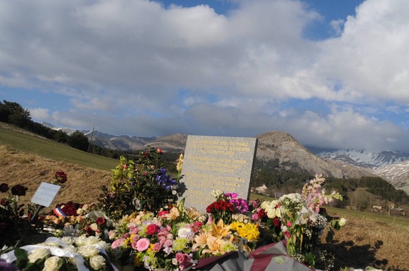 The Village Of Missing Toddler May Be Cursed After Earlier Tragedies File photo dated April 5, 2015 - Flowers lay at a memorial stele made of stone that reads In commemoration of the victims of the pl ...
