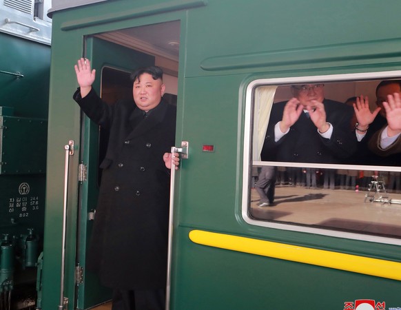 epa07391627 A photo released by the official North Korean Central News Agency (KCNA) shows North Korean leader Kim Jong-un (C) waving as he boards a train in Pyongyang, North Korea, 23 February 2019 ( ...