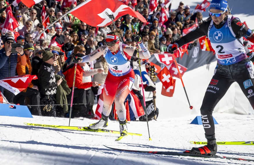 Lena Haecki-Gross of Switzerland, left, and Franziska Preuss of Germany, right, compete during the women?s 10k pursuit race at the IBU Biathlon World Championships, on Sunday, February 16, 2025, in Le ...