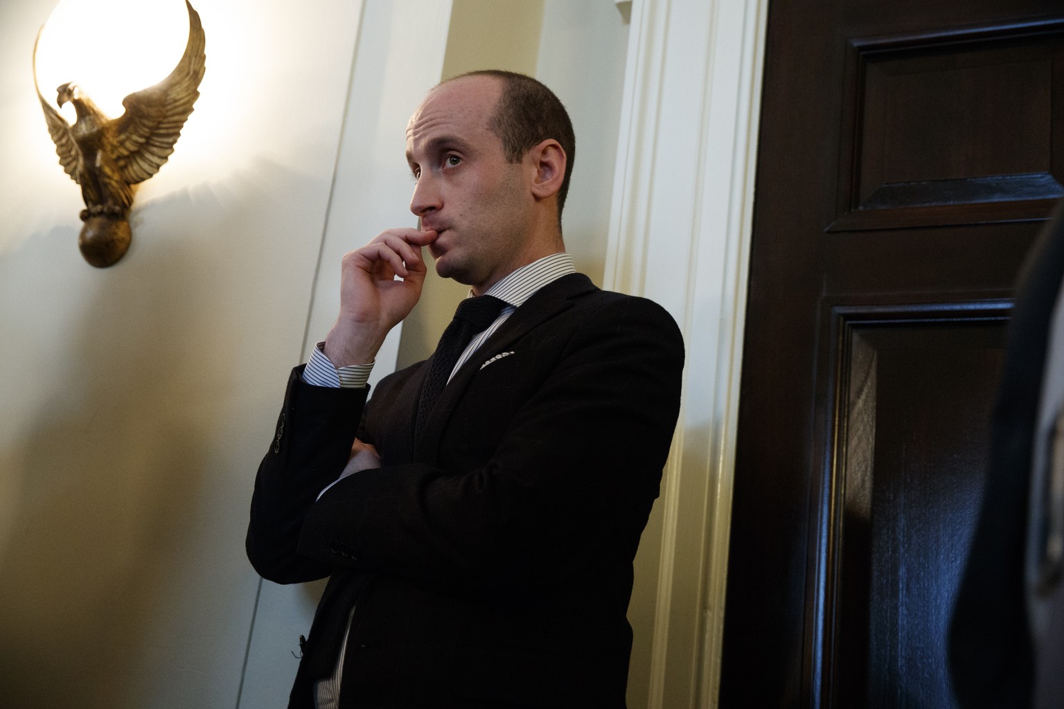 Senior White House adviser Stephen Miller listens as President Donald Trump speaks during a meeting with lawmakers on immigration policy in the Cabinet Room of the White House, Tuesday, Jan. 9, 2018,  ...