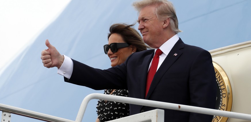 President Donald Trump and first lady Melania Trump step off Air Force One as they arrive at the Palm Beach International Airport, Thursday, April 6, 2017, in West Palm Beach, Fla., en route to Mar-a- ...