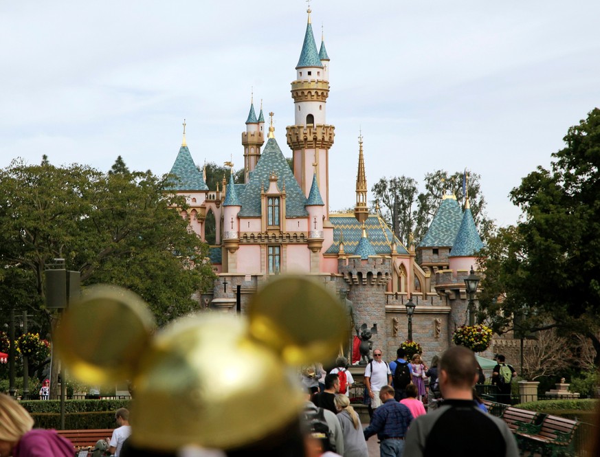 FILE - In this Jan. 22, 2015 file photo, visitors walk toward Sleeping Beauty&#039;s Castle at Disneyland Resort in Anaheim, Calif. Authorities say thieves made off with 8,000 Disneyland tickets when  ...