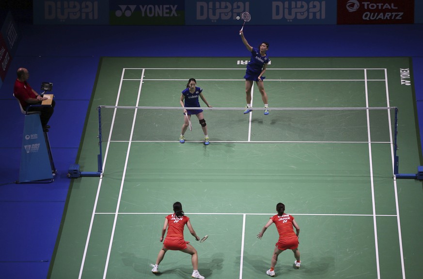 Japanese Badminton duo Ayaka Takahashi, right, and Misaki Matsumoto return a shot to to their fellow country players Naoko Fukuman and Kurumi Yonao during the World Superseries Finals Badminton tourna ...