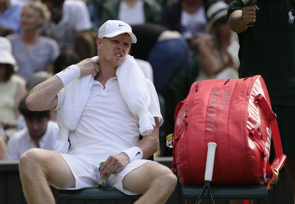 Britain's Kyle Edmund wears an ice belt on his neck during a break in play against Spain's Fernando Verdasco returns Men's singles match during day three of the Wimbledon Tennis Champio ...