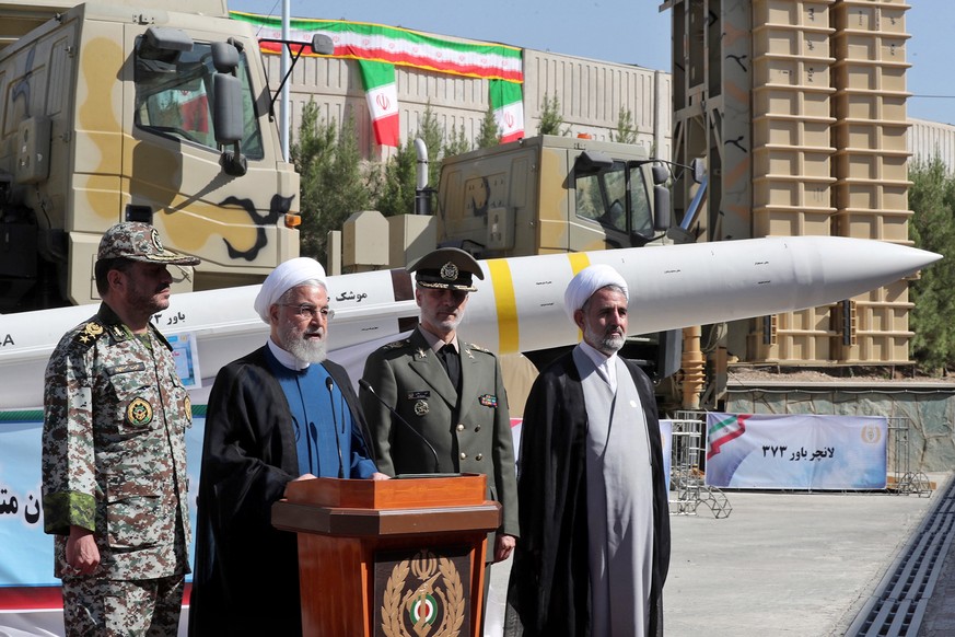 epa07785591 A handout picture made available by Iran&#039;s Presidential Office shows Iranian President Hassan Rouhani (2-L) delivering a speech next to Iranian Defense Minister Amir Hatami (2-R) duri ...