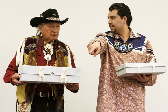 epa10453060 The two representatives of Haudenosaunee Confederacy Clayton Logan (L) (Seneca Nation), and Brennen Ferguson (Tuscarora Nation), hold boxes containing sacred objects during the ceremony of ...