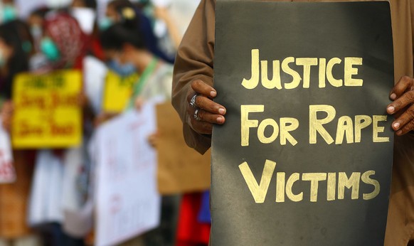 epa08666061 Activists of V-care welfare trust hold placards during a protest against an alleged gang rape of a woman, Karachi, Pakistan, 13 September 2020. According to reports, two persons allegedly  ...