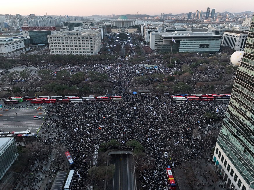 epa11776191 Protesters gather near the National Assembly during a rally in support of an impeachment motion against President Yoon Suk Yeol in Seoul, South Korea, 14 December 2024. South Korean parlia ...