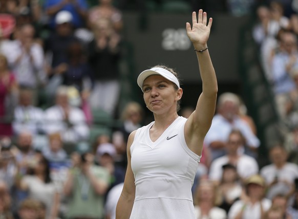 Romania's Simona Halep celebrates defeating China's Shuai Zhang in a women's quarterfinal match on day eight of the Wimbledon Tennis Championships in London, Tuesday, July 9, 2019. (AP ...