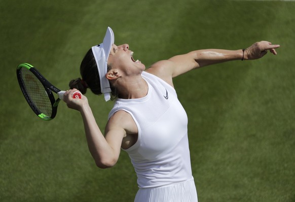 Romania&#039;s Simona Halep serves to Romania&#039;s Mihaela Buzarnescu in a Women&#039;s singles match during day three of the Wimbledon Tennis Championships in London, Wednesday, July 3, 2019. (AP P ...