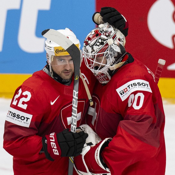 Switzerland&#039;s Nino Niederreiter, left, and Goalkeeper Akira Schmid celebrate their victory during the Ice Hockey World Championship group A preliminary round match between Switzerland and Great B ...