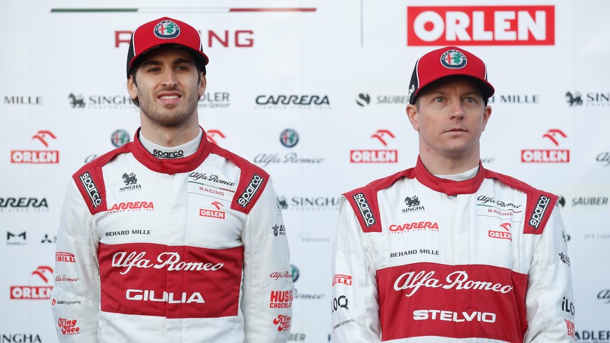 epa08228674 Italian Formula One driver Antonio Giovinazzi (L) and Finish Formula One driver Kimi Raikkonen, both of Alfa Romeo, present their new car during the pre-season tests at Barcelona-Cataluna  ...