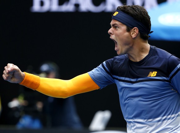 Milos Raonic of Canada celebrates after defeating Stan Wawrinka of Switzerland during their fourth round match at the Australian Open tennis championships in Melbourne, Australia, Monday, Jan. 25, 201 ...