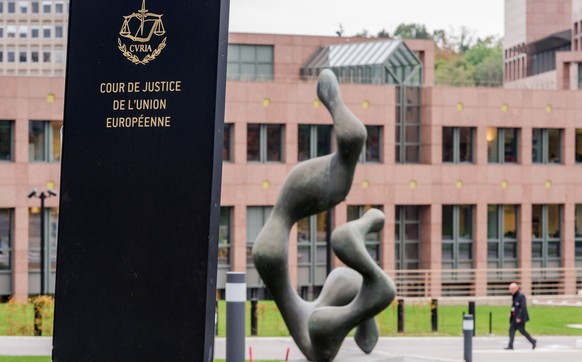 In this photo taken on Monday, Oct. 5, 2015 a man walks by the European Court of Justice in Luxembourg. The European Unions highest court has ruled that a member state can ban prisoners guilty of ser ...
