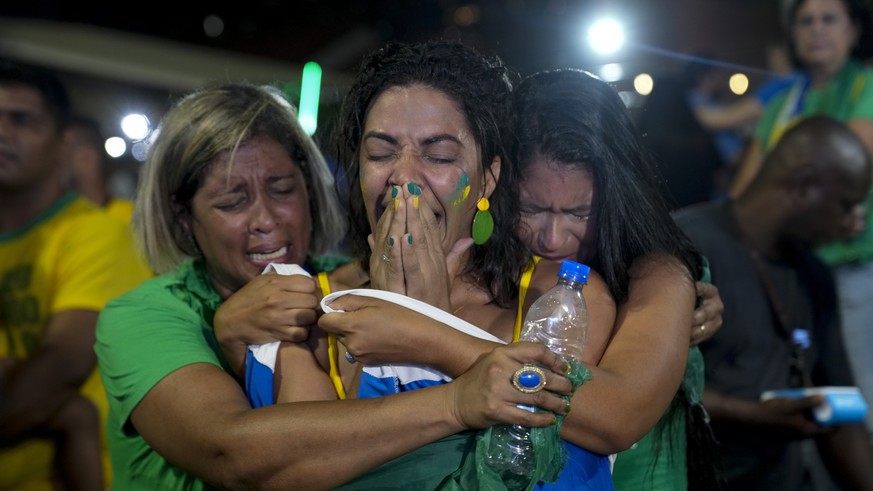 Supporters of Brazilian President Jair Bolsonaro react to results after polls closed in a presidential run-off election, in Rio de Janeiro, Brazil, Sunday, Oct. 30, 2022. Brazil&#039;s electoral autho ...