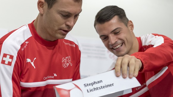 Stephan Lichtsteiner, left, and Granit Xhaka, right, attend a press conference of Switzerland's national soccer team, the day before the 2018 FIFA World Cup play-off second leg soccer match between Sw ...