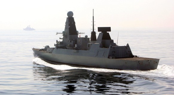 epa04177618 A photo taken and made available by the British Ministry of Defence (MoD) on 23 April 2014 shows 'HMS Dragon' (R) accompanying the Russian destroyer Vice Admiral Kulakov (backgro ...