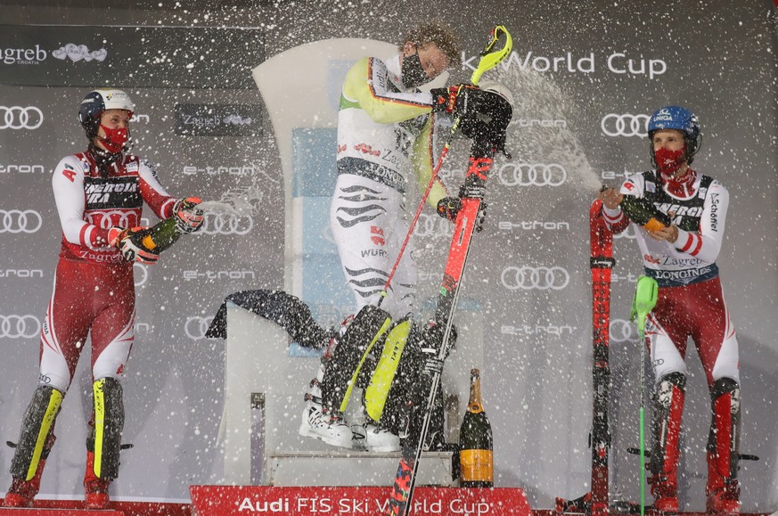epa08922606 (L-R) Second placed Manuel Feller of Austria, winner Linus Strasser of Germany and third placed Marco Schwarz of Austria celebrate on the podium after the FIS Alpine Skiing World Cup Men&# ...