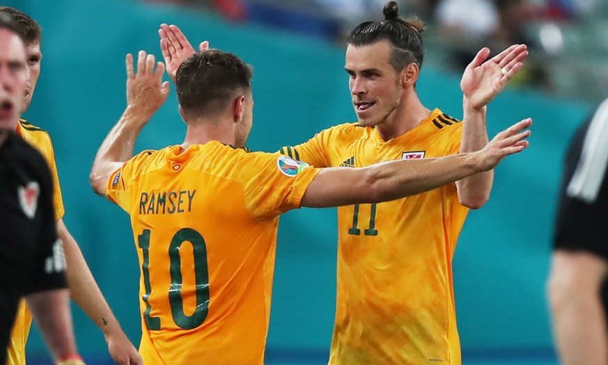 epa09277207 Aaron Ramsey (L) of Wales celebrates with team-mate Gareth Bale (R) after scoring the 0-1 goal during the UEFA EURO 2020 group A preliminary round soccer match between Turkey and Wales in  ...