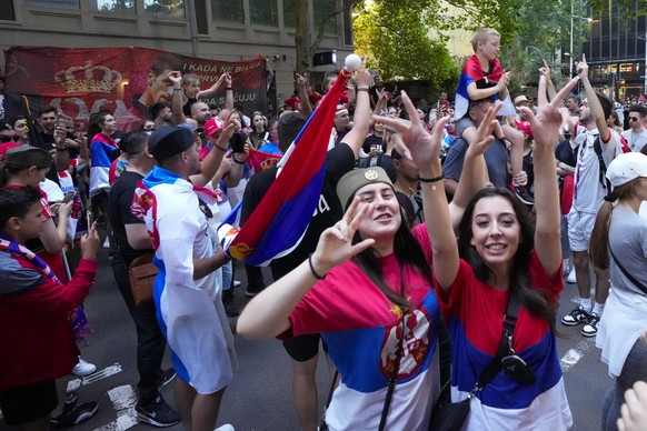 Fans dance and sing outside an immigration detention hotel where Serbian Novak Djokovic is confined in Melbourne, Australia, Monday, Jan. 10, 2022. An Australian judge who will decide whether top-rank ...