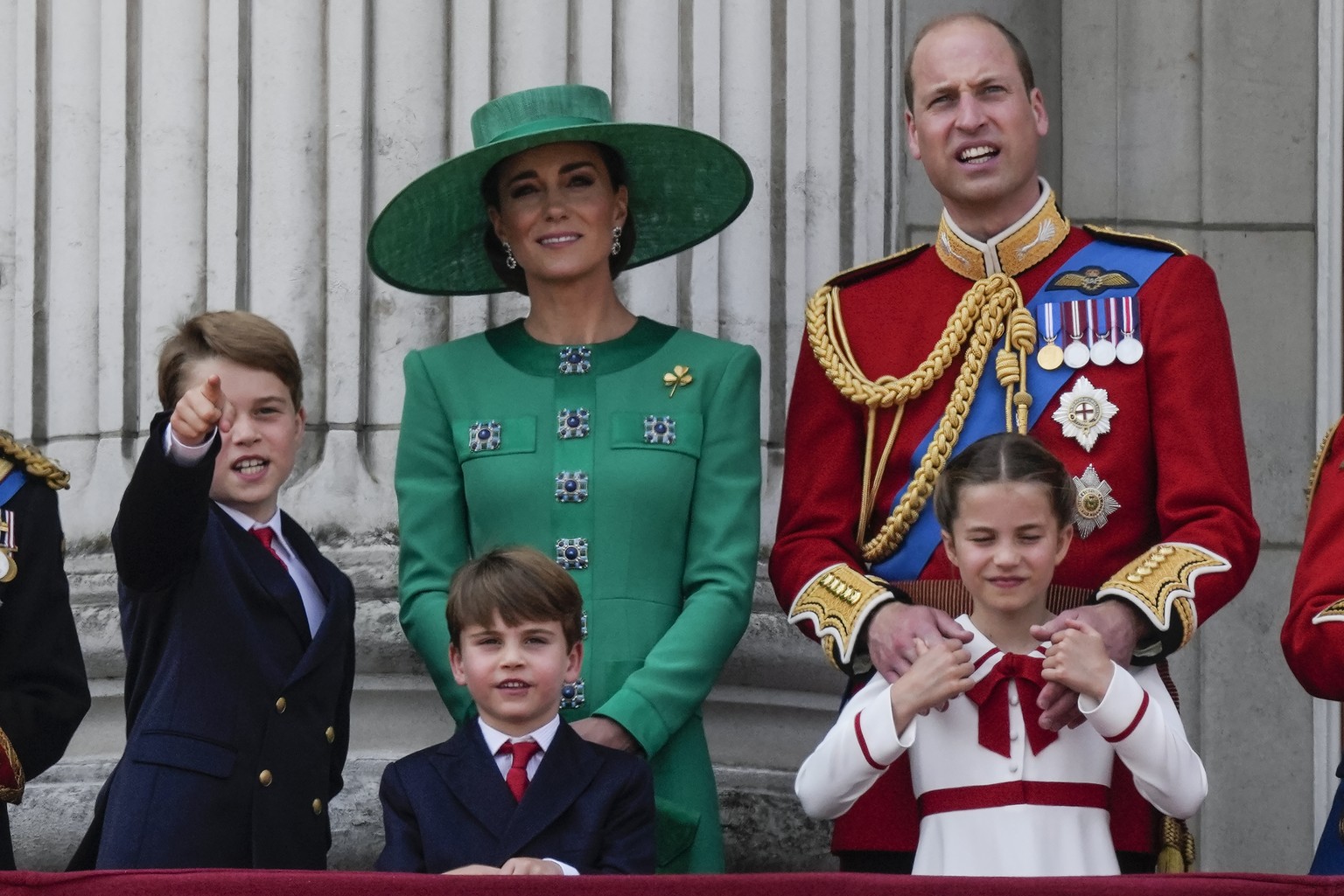 FILE - Prince William, right, Kate, Princess of Wales, centre, Princess Charlotte, bottom right, Prince George, left, and Prince Louis greet the crowd from the balcony of Buckingham Palace after the T ...