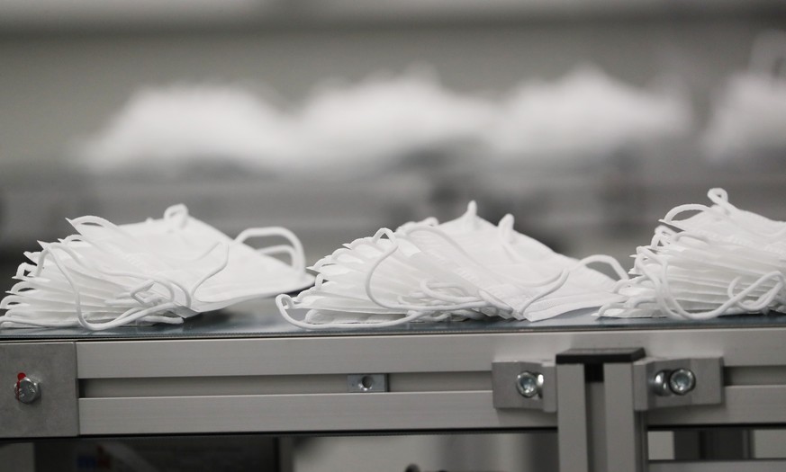 epa08658582 Face masks at the face mask production unit of German automotive supplier Continental in Hannover-Stoecken, northern Germany, 10 September 2020. Continental intends to make about 80.000 ty ...