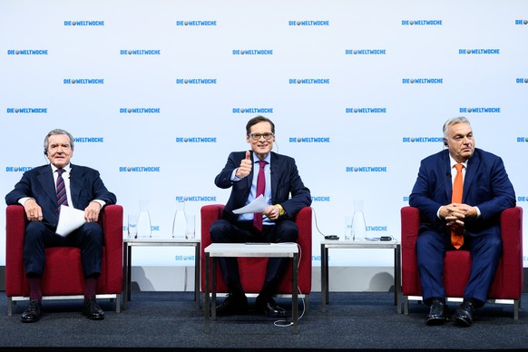epa11694532 (L-R) Former German Chancellor Gerhard Schroeder, Die Weltwoche editor-in-chief Roger Koeppel, and Prime Minister of Hungary, Viktor Orban participate a panel discussion titled 'Peace ...