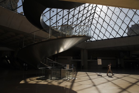 A man walks at the Louvre museum ahead of its reopening next July 6, in Paris, Tuesday, June 23, 2020. After four months of virus-imposed inactivity, the world&#039;s most visited museum is counting o ...