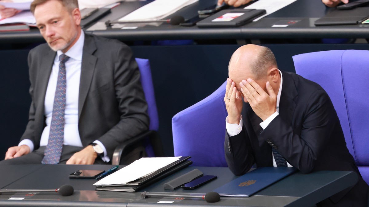 epa11705997 (FILE) - German Chancellor Olaf Scholz (R) reacts after delivering a government declaration, as he sits next to German Finance Minister Christian Lindner (L), in the German parliament  ...