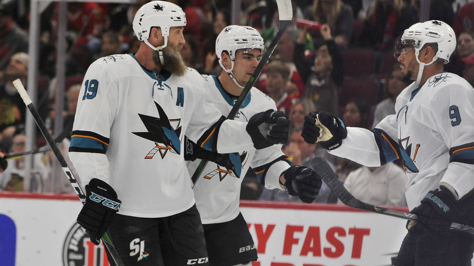 San Jose Sharks&#039; Evander Kane (9) celebrates with teammates Joe Thornton (19) and Timo Meier (28) of the Czech Republic, after scoring a goal during the first period of an NHL hockey game against ...