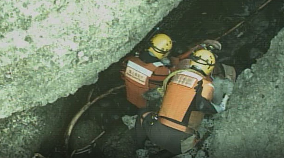 In this photo released by the 1st Regional Japan Coast Guard Headquarters, rescuers attend a person found on a rocky area near the tip of Shiretoko Peninsula in northern Japan of Hokkaido Sunday, Apri ...