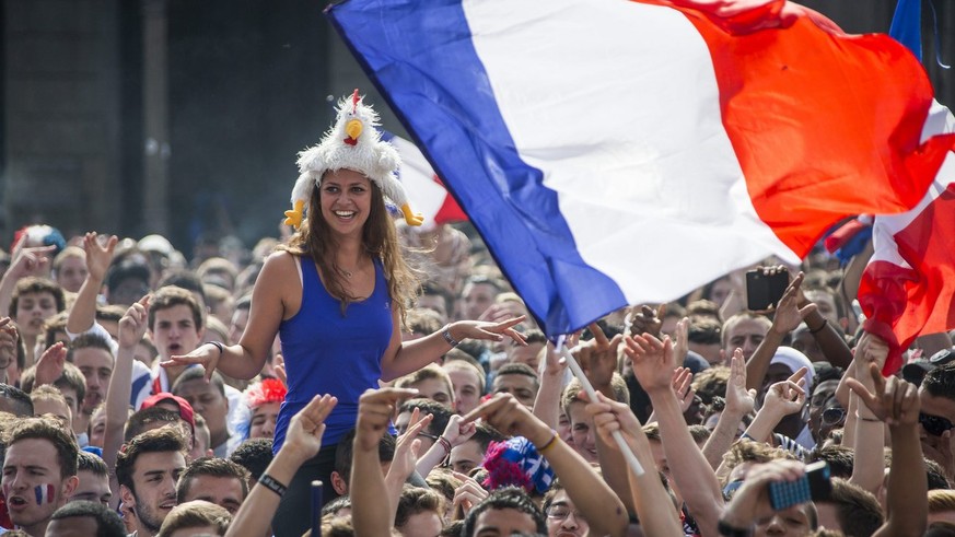 epa04299333 Spectators gather to watch the FIFA World Cup 2014 quarter final soccer match between France and Germany on a giant screen in front of Hotel de Ville (Town Hall) in Paris, France, 04 July  ...