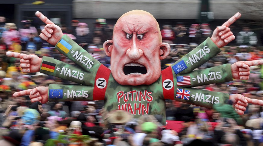 epa10480063 A carnival float depicting Russian President Vladimir Putin parades during the annual Rose Monday (Rosenmontag) parade in Duesseldorf, Germany, 20 February 2023. Rose Monday is the traditi ...
